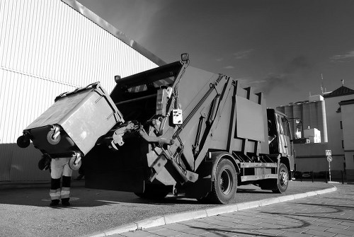 Man and van loading bulky items from a shopfront for disposal